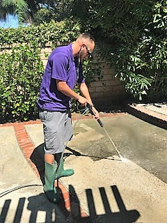 Cleaning off a patio with our state of the art pressure washing machine