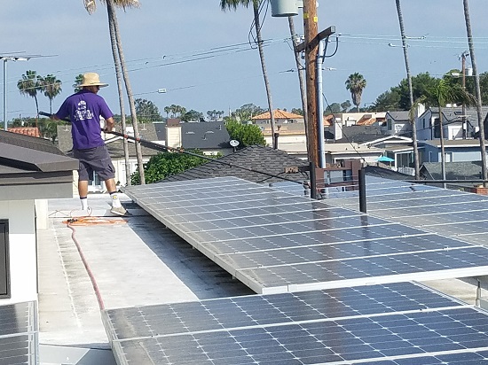 Hard at work cleaning these large solar panels in OC