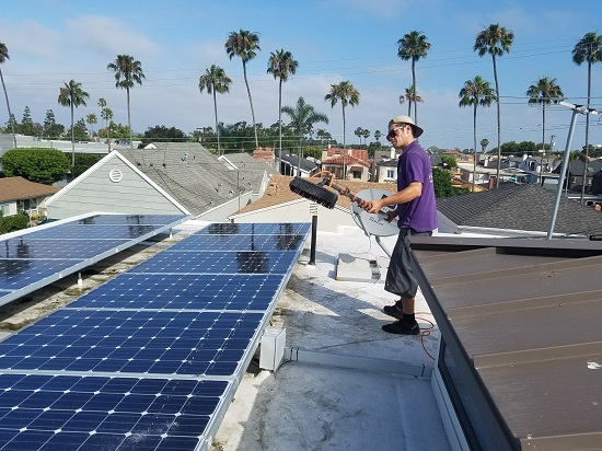 keeping the sun off our heads as we clean this large set of solar panels in Huntington Beach